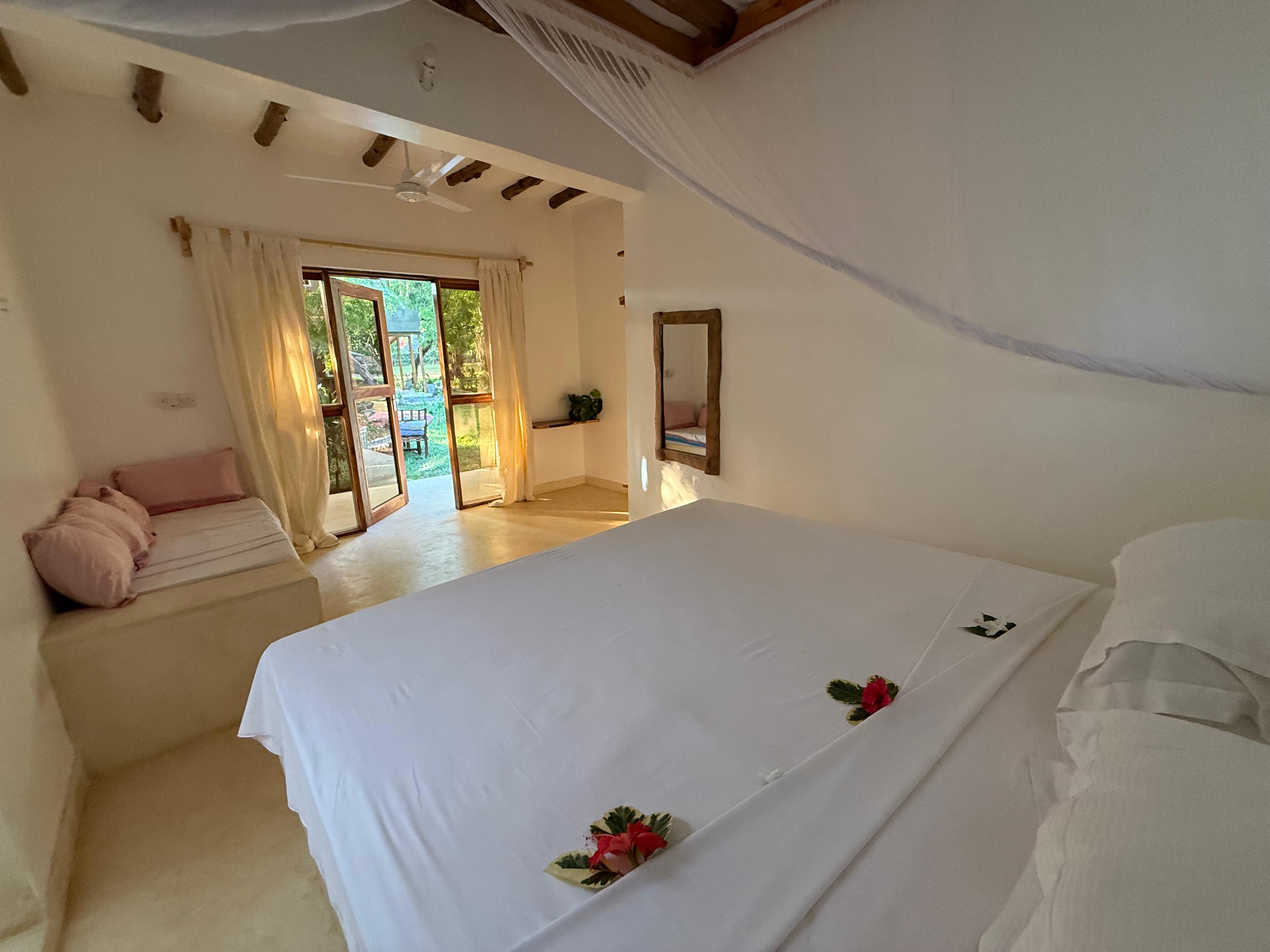 The Garden Suite with French doors open to the garden